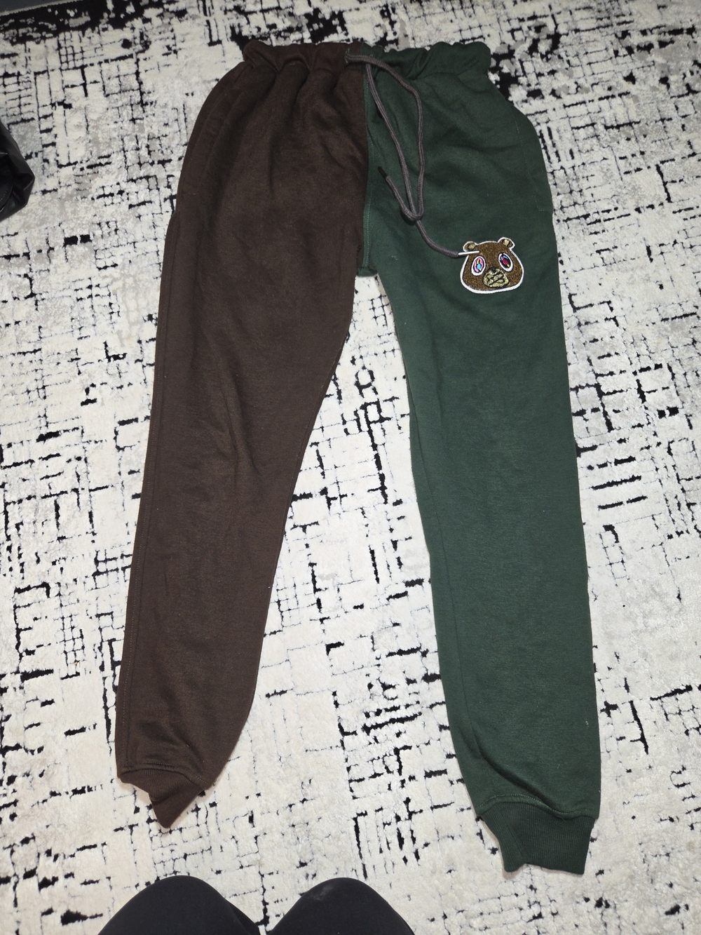 OWNYC two-tone split color sweatpants featuring an embroidered bear patch Mens s